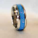 Titanium band, light blue shimmer, subtle opalescent flecks, white opal, heavy ashes ( ashes are very fine)