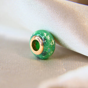 Rose gold bead, esmeralda green shimmer, cat whiskers and ashes lightly sprinkled 