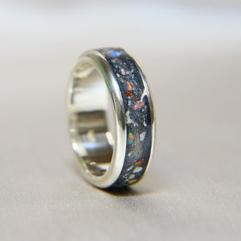 Titanium band, charcoal grey shimmer, heavy ashes, white opal, subtle rose gold flecks 