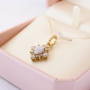 Solid gold breastmilk pendant with crushed amythyst birthstone